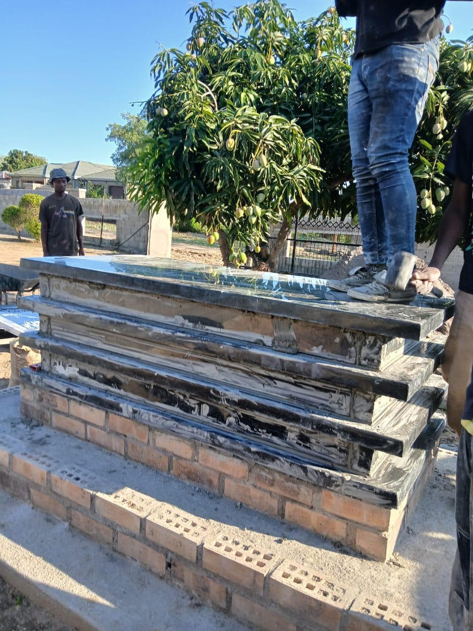 Weathered and dirty tombstone before cleaning